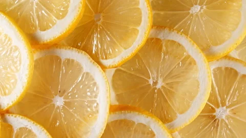 Slow Motion of Fresh Lemons Slices on Yellow Background. Lemons Fruit Pattern Stock Footage 161080337