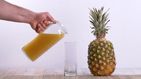 Slow Motion of Fresh Pineapple Juice Poured Into A Transparent Glass 스톡 동영상 130514455