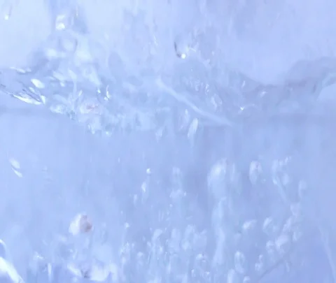 Slow motion freshness ice cube drop to bright water Video stock 89722593