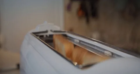 Slow motion, fried bread popping out of a toaster. Closeup. Move camera Stock Footage 119539692