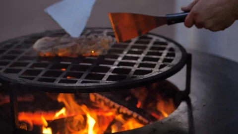 Slow motion. fried steak on the charcoal grill. Chef turns the meat. close-up 스톡 동영상 126812397