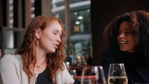 Slow motion of friends looking at phone in bar Stock Footage 159576567