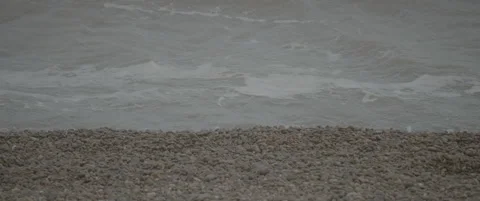 Slow Motion Front-On Close-Up of Waves Lapping on Shingle Beach Stock-Footage 320114855