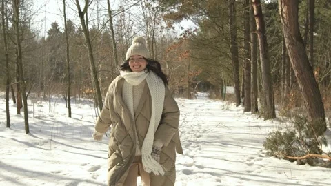 Slow motion. Front view. The model runs in a snowy forest. Stock Footage 154209560