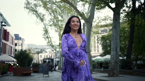 Slow motion front view of pretty young lady walking in the urban street Stock Footage 239153579