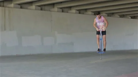 Slow motion. Front view. Young athletic man practicing jumps. Stock Footage 68756105