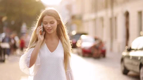 Slow motion front view of a young beautiful blonde woman in a white dress Stock Footage 138514893