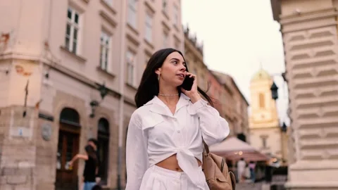 Slow motion front view of a Young beautiful woman in stylish clothes walking and Stock Footage 143028620