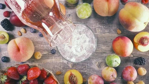 Slow motion fruit drink with ice top view Stock Footage 93198029