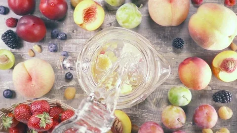 Slow motion fruit drink with ice top view Stock Footage 93198256