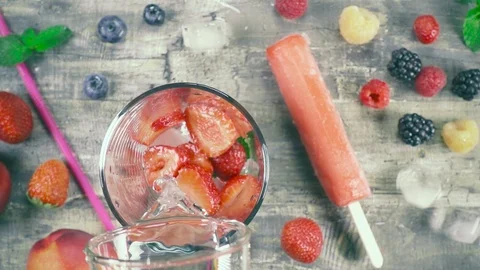 Slow motion fruit drink with ice top view Stock Footage 93200100