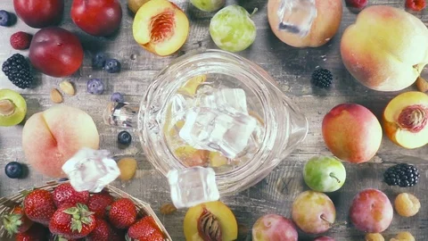 Slow motion fruit drink with ice in a glass top view Stock Footage 93239143
