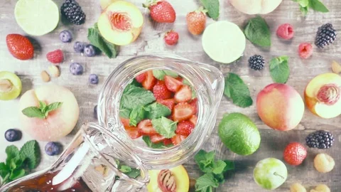 Slow motion fruit drink with ice in a glass top view Stock Footage 93239335
