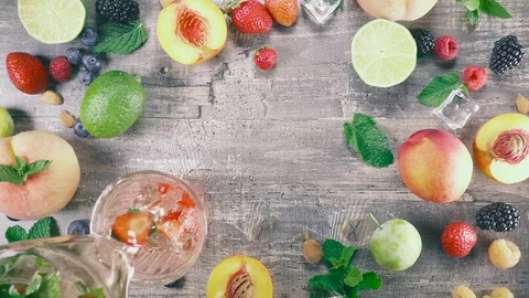 Slow motion fruit drink with ice in a glass top view Stock Footage 93239726