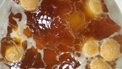 Slow motion frying with brownish black used cooking oil Stock Footage 320978166