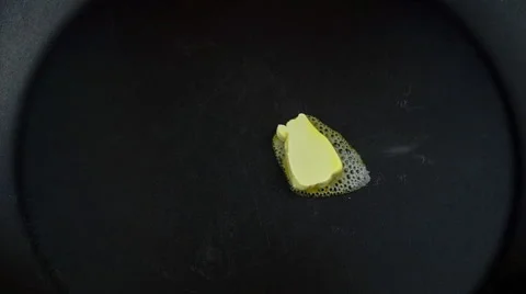 Slow motion frying an egg in a pan with butter Stock Footage 47002993