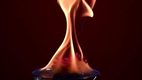 A Slow motion Full HD video of Flames pulsing over a floating rose Stock Footage 202623444