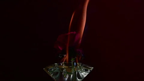 A Slow motion Full HD video of Flames pulsing over a floating rose Stock Footage 203020999