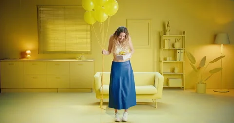Slow motion of a full length carefree woman holding a gift box and balloons Stock Footage 188087461