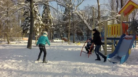 Slow motion, Funny children rush into each other with snow. 库存影片 87543456