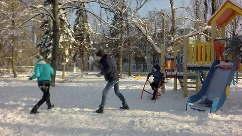 Slow motion, Funny children throw snow at each other. Video stock 87543516