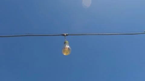 Slow motion of garden light bulb swaying in the wind Stock Footage 320103177