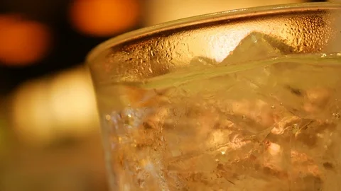 Slow motion gas bubble floating in glass drink of ice beverage refreshment Stock Footage 89787943