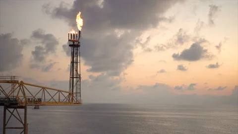 Slow motion of gas flare from bottom burning at oil and gas platform with backgr Stock Footage 153857746
