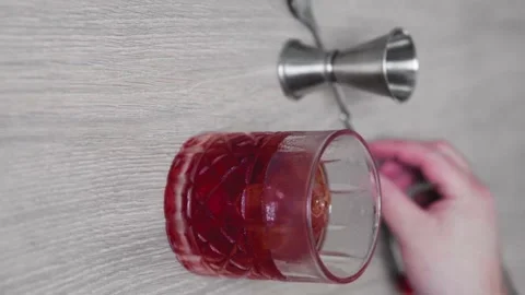 Slow motion of a general shot of a glass of negroni cocktail with an out of f Stock Footage 156564162