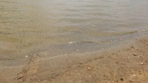 Slow motion of gentle ripples on the surface of the water lake Stock Footage 323149095