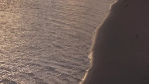 Slow motion of gentle sea waves touching shoreline at sunset in coastal Taiwan Stock Footage 312278194