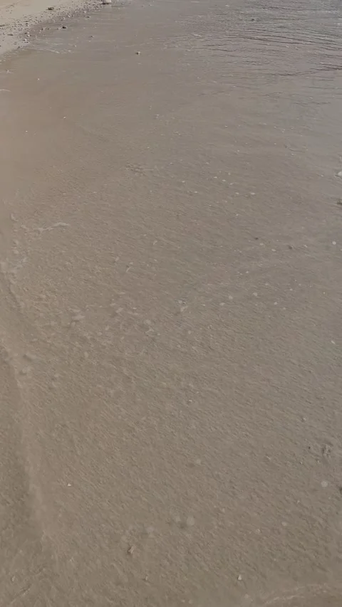 Slow Motion of Gentle Waves Washing Ashore on Sandy Beach Stock Footage 334907182