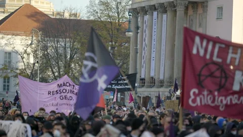 Slow motion German protest march with flags waving for social economic Stock Footage 225833748