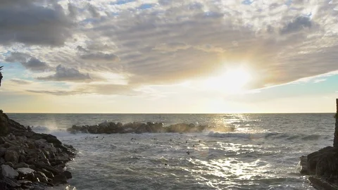 Slow motion - giant waves crash against marina jetty at sunset Stock Footage 103197237