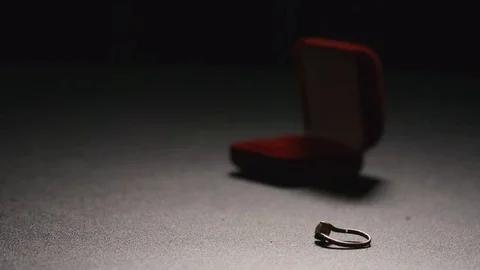 SLOW MOTION: Gift box with a golden ring fall on a floor Stockbeeldmateriaal 72273897