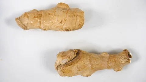 Slow motion ginger root vegetable, two whole ginger herb root Stock Footage 88339948