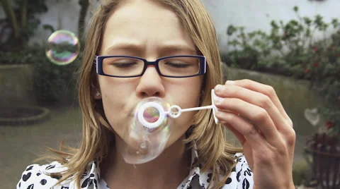 Slow motion girl blowing bubbles Stock Footage 57317183