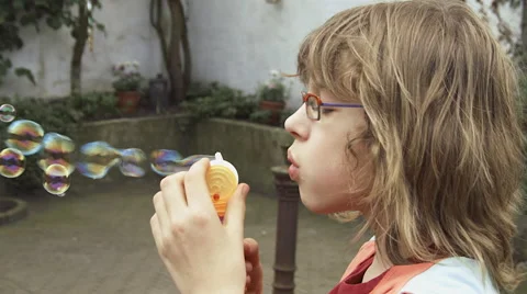 Slow motion girl blowing bubbles Stock Footage 57326044