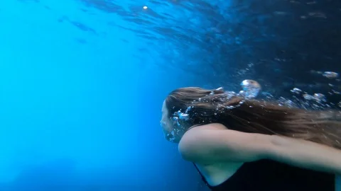 Slow motion of a girl deep diving into the ocean, greece Stock Footage 135319603