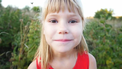 Slow motion girl eats ripe red juicy raspberry in the garden Stock Footage 115515469