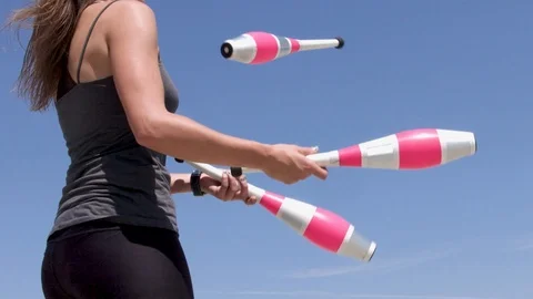 Slow Motion Girl Juggling Clubs Behind the Back Stock Footage