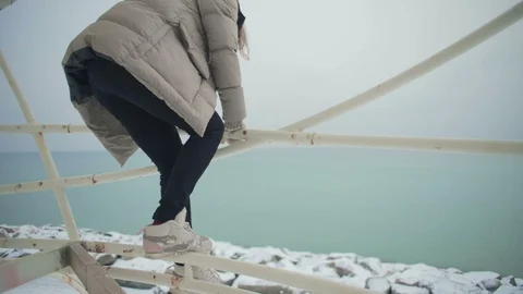 Slow motion girl sits down on tent pipe turns with smile Stock Footage 102084663