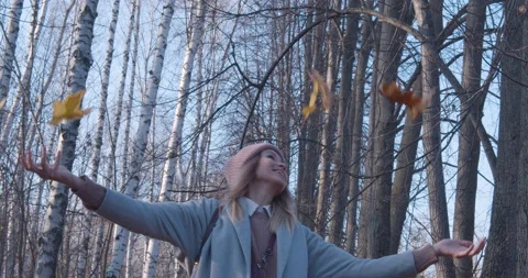 Slow motion-Girl throws maple leaves Stock Footage 142717092