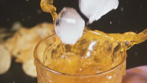 Slow motion in the glass with a drink falls ice Stock Footage 87795576