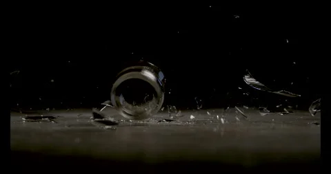 Slow Motion of a Glass Falling on a Table and Shattering Stock Footage 270406277