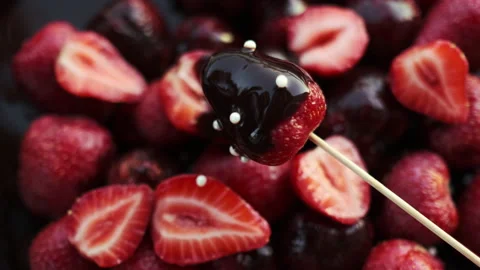 Slow Motion of Glazed Chocolate Candies with Ripe Strawberry and Dark Chocolate Stock Footage 194574115