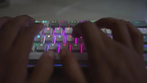 Slow motion glowing mechanical keyboard typing Stock Footage 290946895