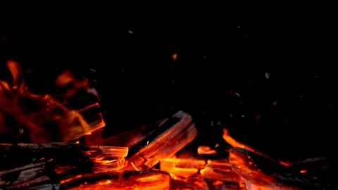 Slow motion Glowing red fire embers or logs and wood ashes in flames, blowing Stock Footage 86540009