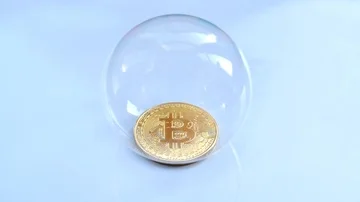 Slow motion - gold btc bitcoin coin inside soap bubble popping Stock Footage 85763344