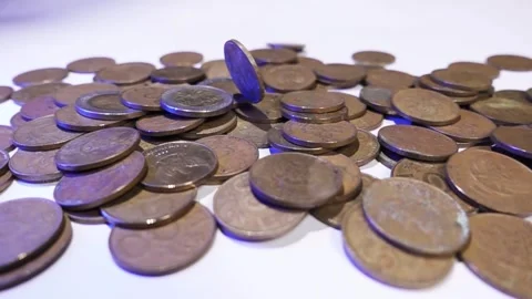 Slow motion of gold coin falling on pile. Stock Footage 287742667